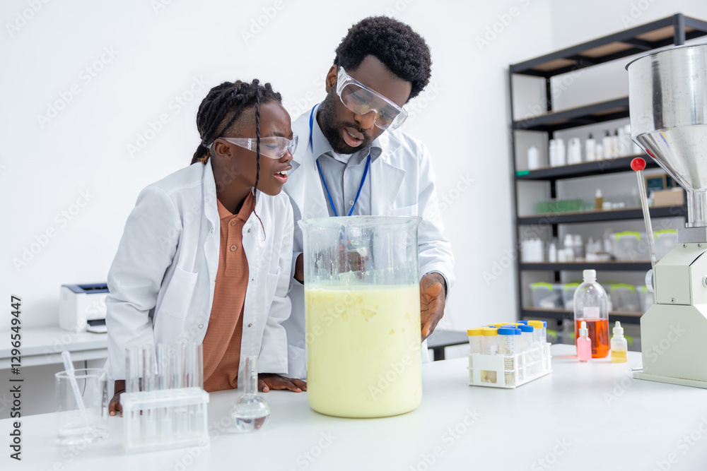 Teacher and student in protective glasses working on a scientific experiment Teacher and student in protective glasses working on a scientific experiment