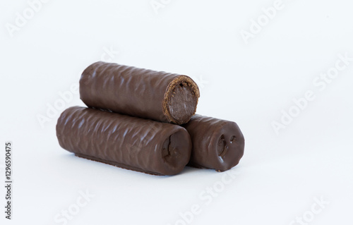 Sweet chocolate covered rolls - table arrangement, isolated on white background. Selective focus. Copy space.