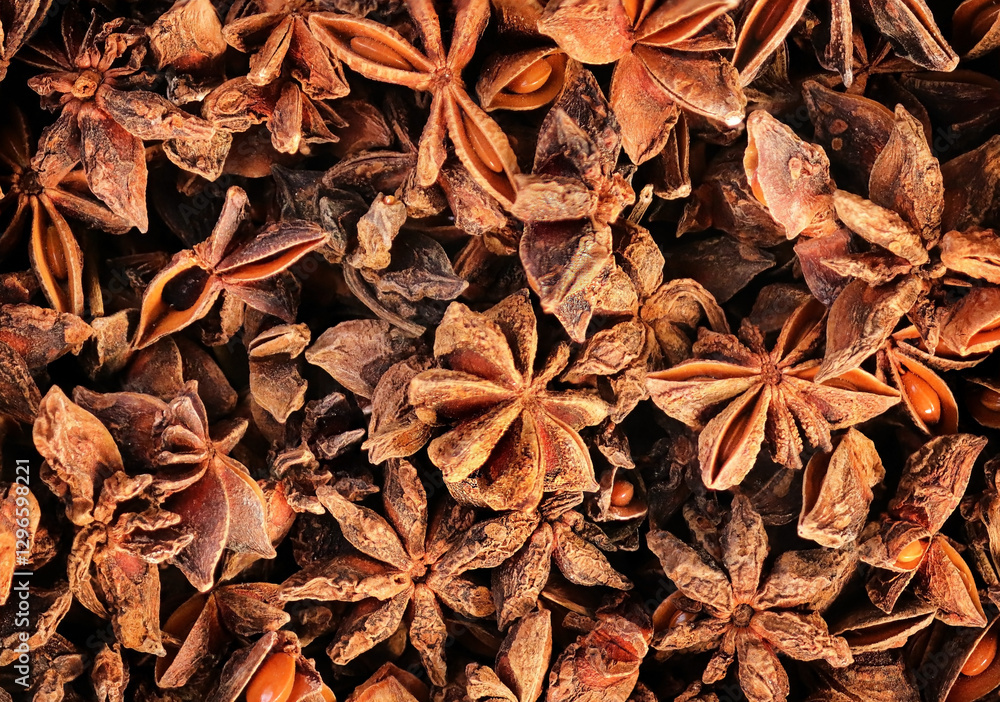 dried aniseed, Aromatic anise stars as background, top view. Illicium verum - a spice commonly called star anise, seed, Chinese star anise, or badian, Anasphal, Chakra Phool, Chakramaggi, Takkolam. dried aniseed, Aromatic anise stars as background, top view. Illicium verum - a spice commonly called star anise, seed, Chinese star anise, or badian, Anasphal, Chakra Phool, Chakramaggi, Takkolam.