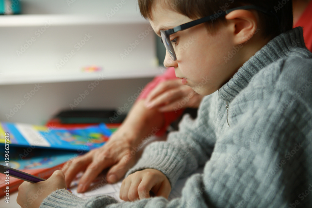 cute boy doing homework with grandma cute boy doing homework with grandma