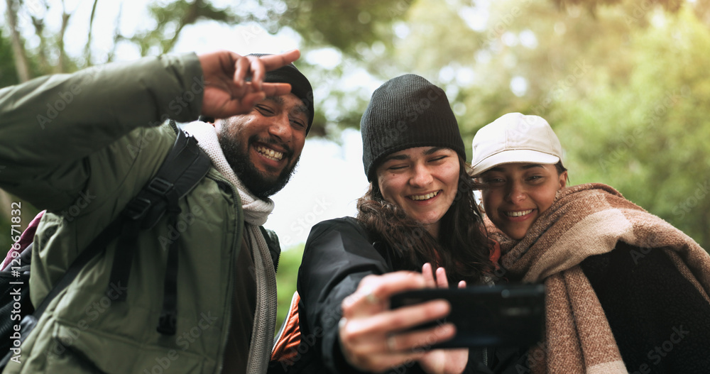 Fototapeta premium Hiking, friends and selfie in a forest with peace hands, hug and smile while bonding outdoor. Phone, profile picture and group of people happy in a jungle for adventure, freedom and trekking fun