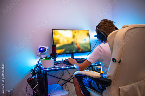 Wallpaper Mural teenager playing computer game at illuminated table in room Torontodigital.ca