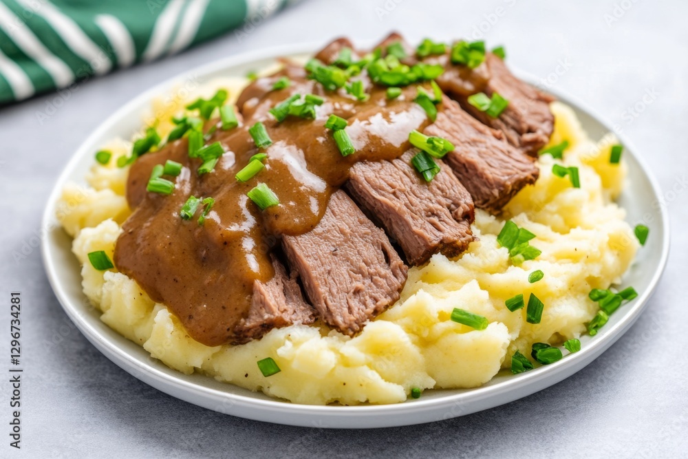 A fresh liver dish served with mashed potatoes and a side of gravy A fresh liver dish served with mashed potatoes and a side of gravy