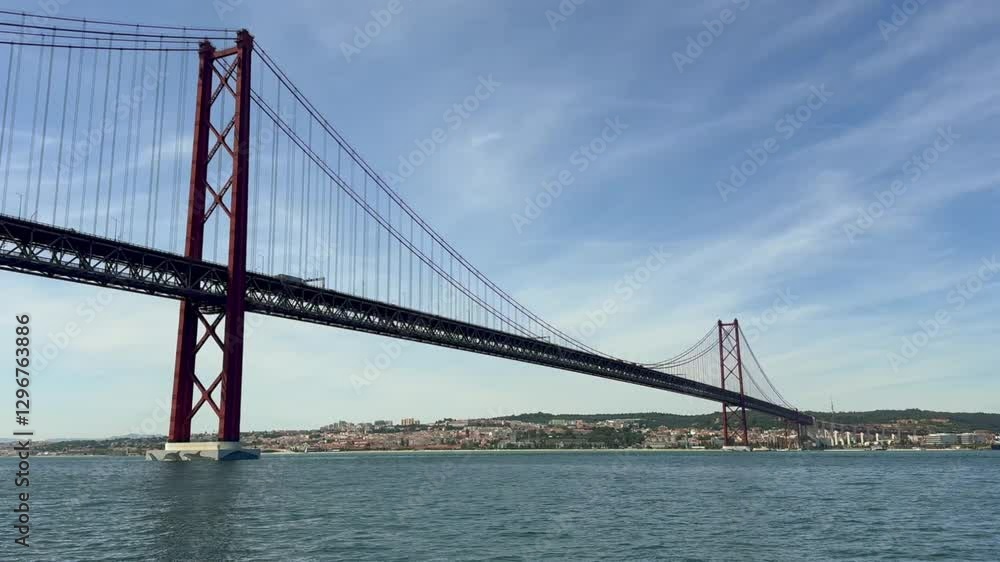 Approaching the 25 de Abril Bridge in Lisbon from a Boat on a Sunny Day Approaching the 25 de Abril Bridge in Lisbon from a Boat on a Sunny Day