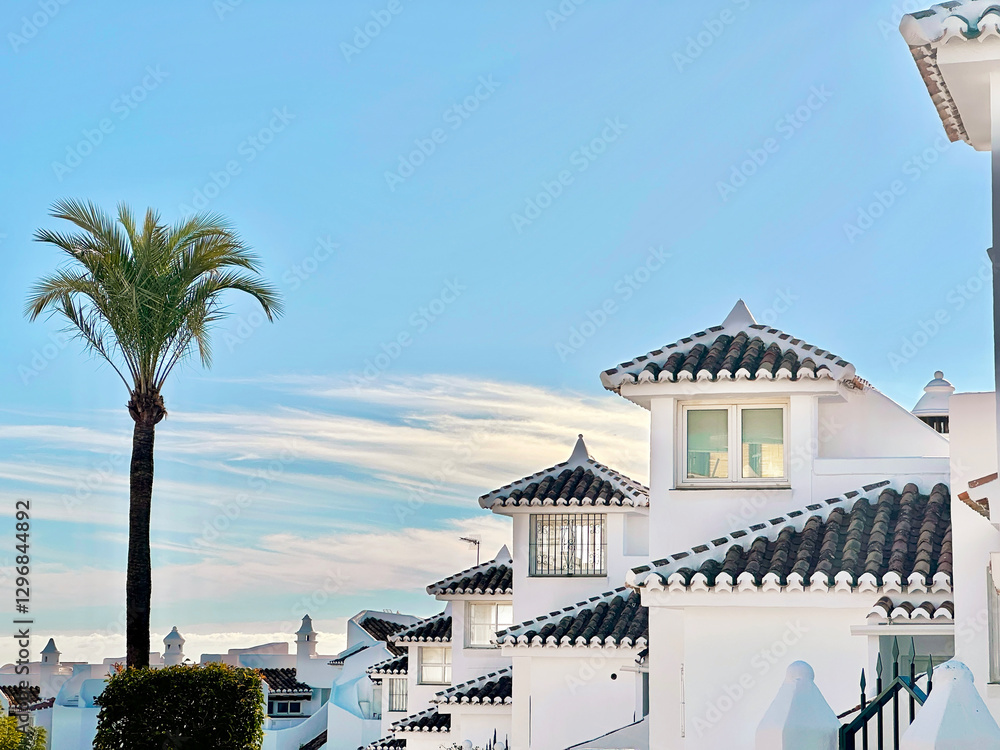 Obraz premium Blue Cloudy Sunset Sky Over Spain Authentic Architecture With Exotic Palm Trees