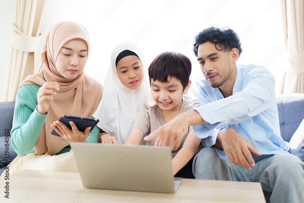 Asian muslim family relaxing in living room together. Asian muslim family relaxing in living room together.