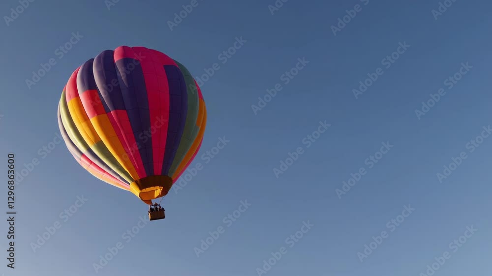 Colorful Hot Air Balloon Against Clear Blue Sky Colorful Hot Air Balloon Against Clear Blue Sky
