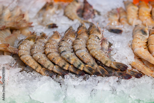 Bustling thailand fish market displaying fresh shrimp on ice photo