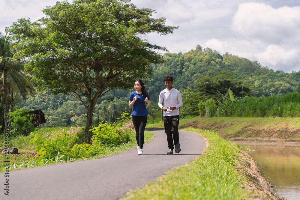 active asian young couple jogging and running exercise at rural area active asian young couple jogging and running exercise at rural area