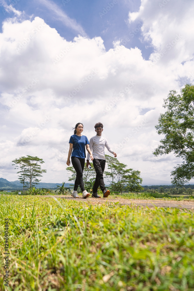 active young asian couple holding water bottle while walking exercise at rural area active young asian couple holding water bottle while walking exercise at rural area