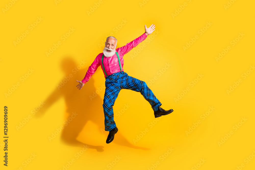 Full body photo of bearded gentleman jump dancing have fun wear fashionable clothes suspenders isolated on vibrant yellow color background Full body photo of bearded gentleman jump dancing have fun wear fashionable clothes suspenders isolated on vibrant yellow color background