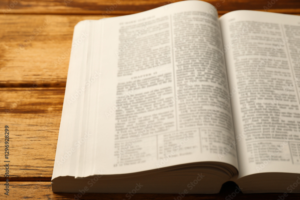 Open Holy Bible in English language on wooden table, closeup Open Holy Bible in English language on wooden table, closeup