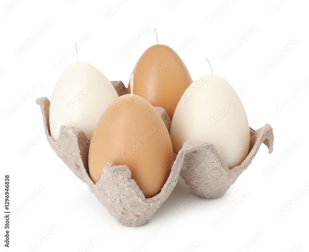 Egg-shaped candles in carton isolated on white. Easter decor Egg-shaped candles in carton isolated on white. Easter decor