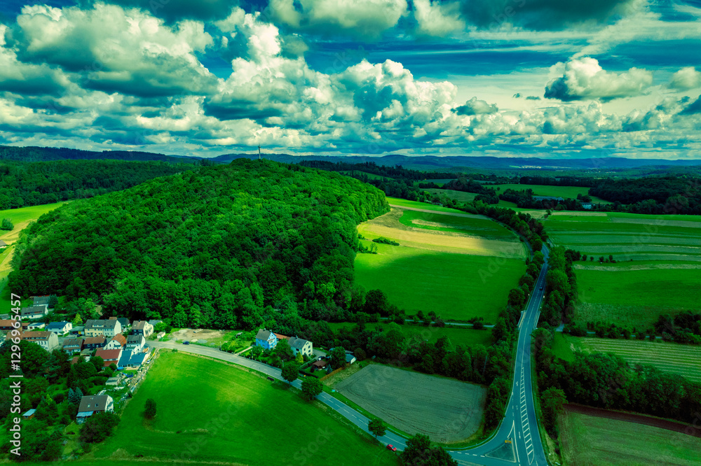 Vibrant German Village Nestled in a Valley Surrounded by Lush Greenery and Picturesque Mountains on a Bright Sunny Day