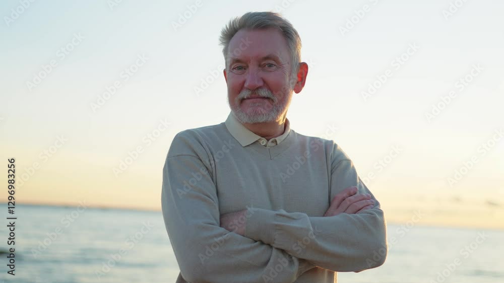 Outdoor portrait of confident stylish European middle aged senior man on beach. Older mature man smiling. Happy senior grandfather looking at camera close up face headshot portrait. Happy people Outdoor portrait of confident stylish European middle aged senior man on beach. Older mature man smiling. Happy senior grandfather looking at camera close up face headshot portrait. Happy people