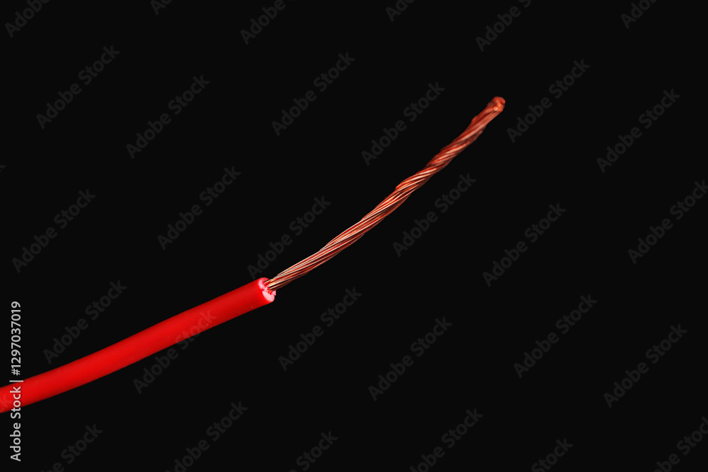 Red stripped electrical wire on black background, closeup Red stripped electrical wire on black background, closeup