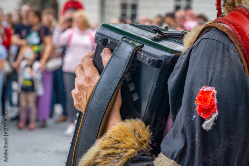 Billede på lærred Folk musician playing accordion during traditional street parade wearing regiona