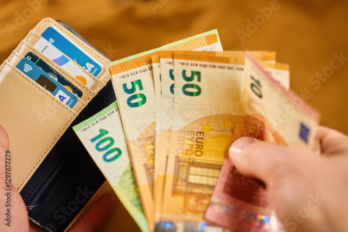 Obraz na płótnie Wallet with euro banknotes and credit cards in hands. Person holding purse and taking out cash money. Concept of personal finance, cash payments and savings w salonie