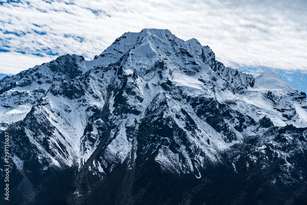 Obraz premium Beautiful Snow Capped Mountains with cloudy blue skies in the Himalayas of Nepal