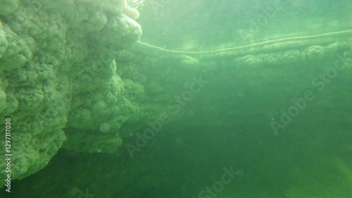 Underwater (GoPro) shot of thick chunks of salt in the Danakil desert in Ethiopia, surreal natural landscape in Africa
