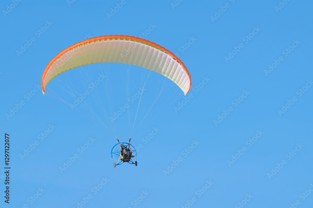 Paraglider in the sky: air tourism, aeronautical device. Paraglider in the sky: air tourism, aeronautical device.