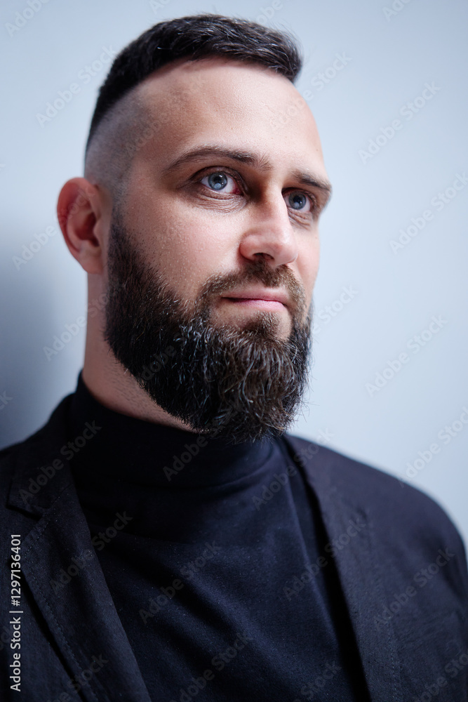 Studio portrait of young handsome man with beard. Studio portrait of young handsome man with beard.
