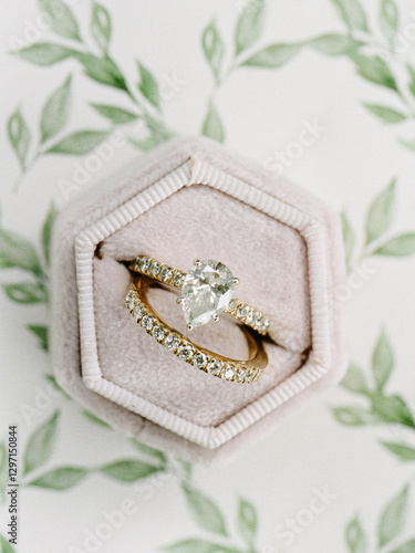 фотографія Elegant heart-shaped engagement ring displayed on a soft cushion with floral bac