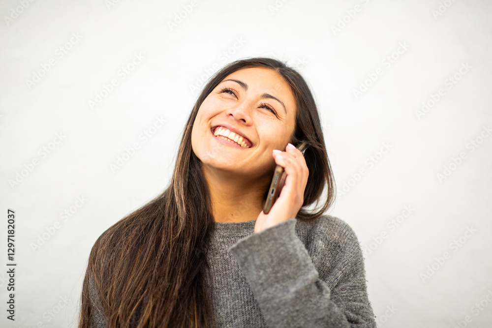 Happy young female talking on the phone with a bright smile Happy young female talking on the phone with a bright smile