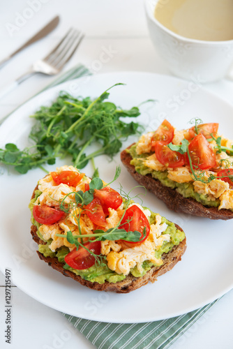 Bruschetta with egg, avocado and herbs for breakfast. Healthy and healthy breakfast, lunch and snack on a plate.