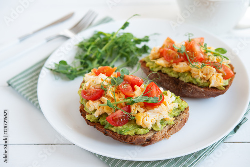 Bruschetta with egg, avocado and herbs for breakfast. Healthy and healthy breakfast, lunch and snack on a plate.