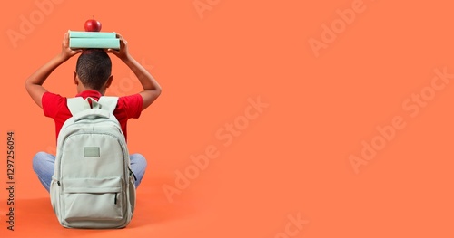 Little schoolboy with backp...