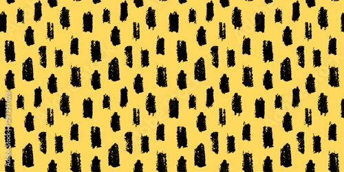 Seamless abstract pattern with irregular black brush strokes on a yellow background. Modern artistic texture for fabric, wallpaper, branding, and creative projects. Trendy and bold hand drawn design.