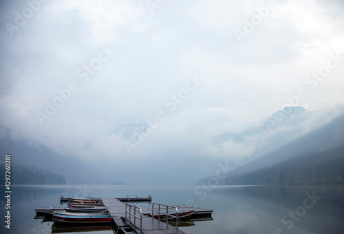 Obraz na płótnie Wooden dock with boats on a misty mountain lake w salonie