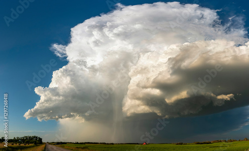 Obraz na płótnie Supercell thunderstorm looming over a rural landscape, generating rain and hail w salonie