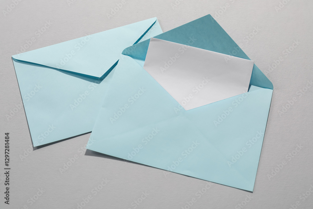Paper envelopes with letter on grey background, top view. Mockup for design Paper envelopes with letter on grey background, top view. Mockup for design