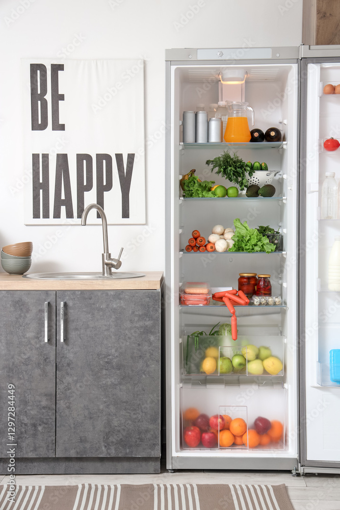 Open big fridge with fresh products in kitchen Open big fridge with fresh products in kitchen