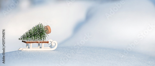 Christmas winter background, banner - view of a decorative Christmas tree with a sled on a snowdrift in a winter forest, copy space for text