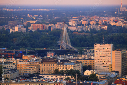Obraz na płótnie Cityscape at sunset - top view of neighbourhood of Powisle and the Swietokrzyski Bridge over the Vistula river, in center of Warsaw, Poland w salonie