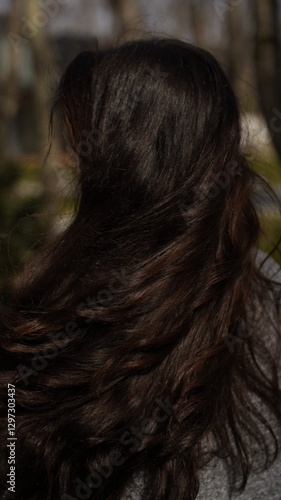 A girl with gorgeous curls and shiny hair.