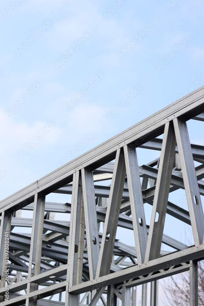 Lightweight steel thin-walled structures. Frames for warehouses, garages or houses. Structure of a steel frame for construction against the sky