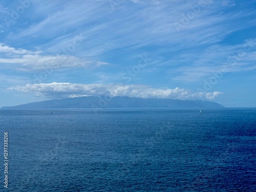 Obraz na plátně Seascape with La Gamora on the horizon, blue sea and sky and rocks