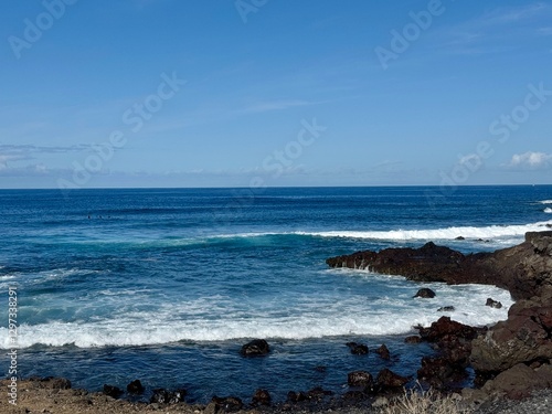 Obraz na plátně Seascape with La Gamora on the horizon, blue sea and sky and rocks