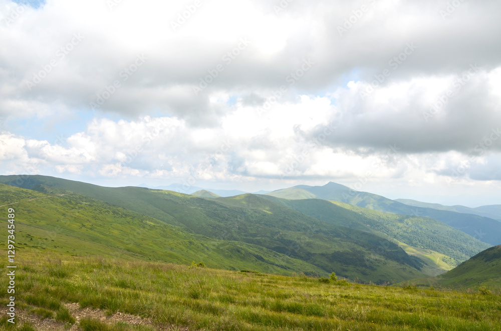 Captivating view showcasing lush green valley, surrounded by mesmerizing mountain ridges under dramatic cloudy sky, conveying sense of peace, nature's beauty, and scenic tranquility. Carpathians Captivating view showcasing lush green valley, surrounded by mesmerizing mountain ridges under dramatic cloudy sky, conveying sense of peace, nature's beauty, and scenic tranquility. Carpathians