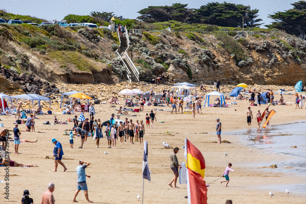 Torquay surf beach in Australia filled with tourists, beach umbrellas, tents, and shelters in various shades. Numerous beachgoers enjoying,sunbathing, relaxing, playing, gathering along the shoreline. Torquay surf beach in Australia filled with tourists, beach umbrellas, tents, and shelters in various shades. Numerous beachgoers enjoying,sunbathing, relaxing, playing, gathering along the shoreline.