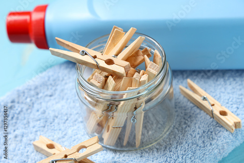 Wooden clothespins in a gla...