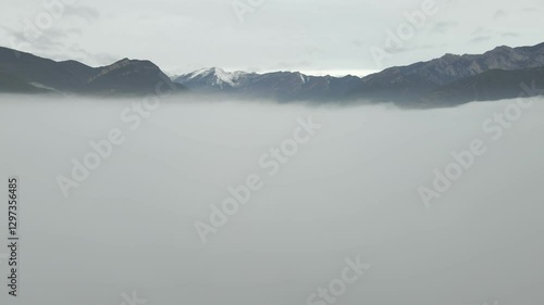 view of the snow-capped mountains above the clouds.