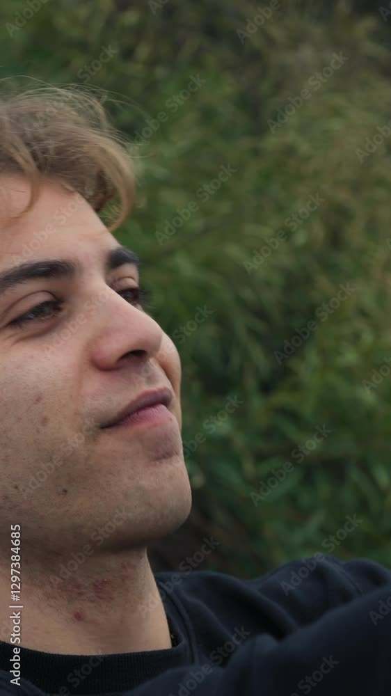 Young Man Takes Vanity Selfies With Smartphone Outside In Nature Young Man Takes Vanity Selfies With Smartphone Outside In Nature