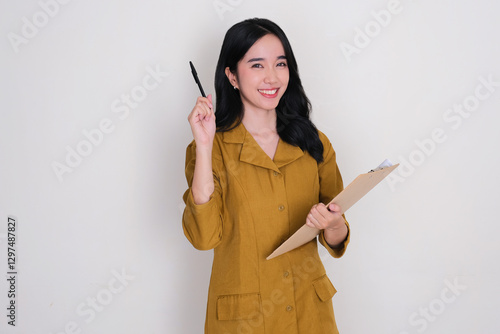 Indonesia government civil staff smiling happy while holding writing pad and pen photo