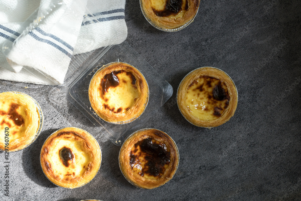 Naklejka premium Egg tart, traditional Portuguese dessert, pastel de nata. Pasteis de Belem is a Portuguese egg custard tart pastry.
