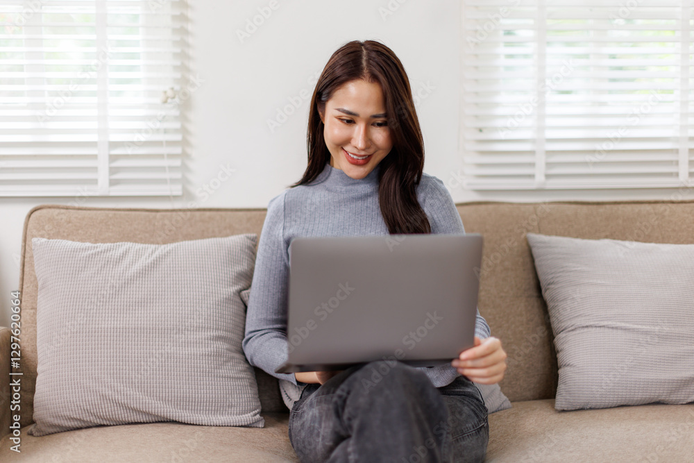 Fototapeta premium Beautiful freelancer happy asian thai lady working on laptop and planning and online at home 